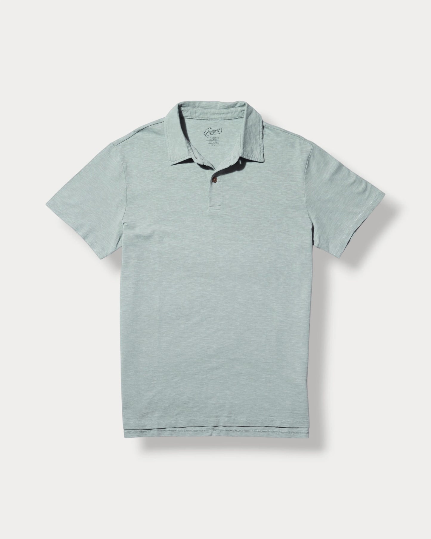 Light blue polo shirt with black trim on a white background