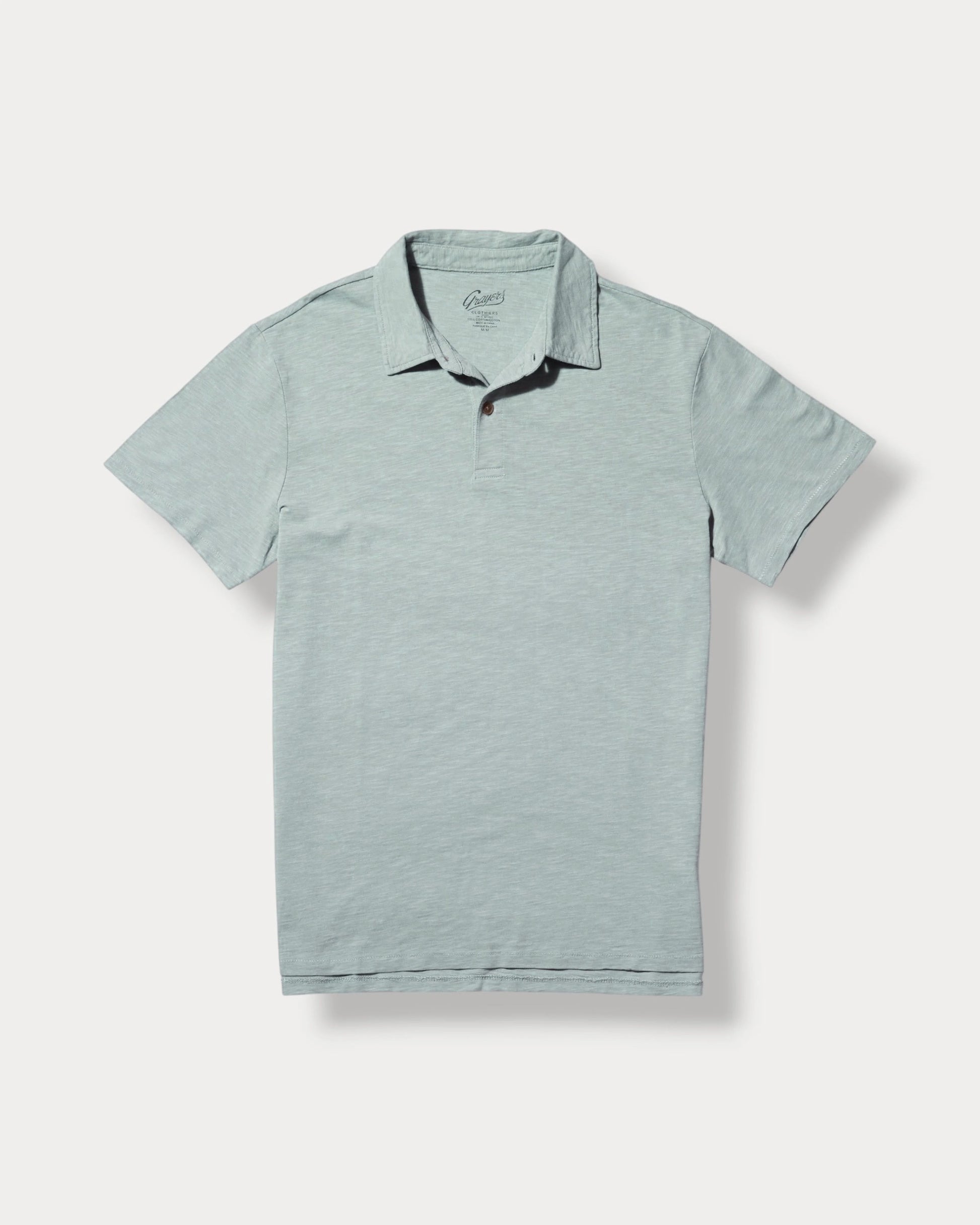 Light blue polo shirt with black trim on a white background