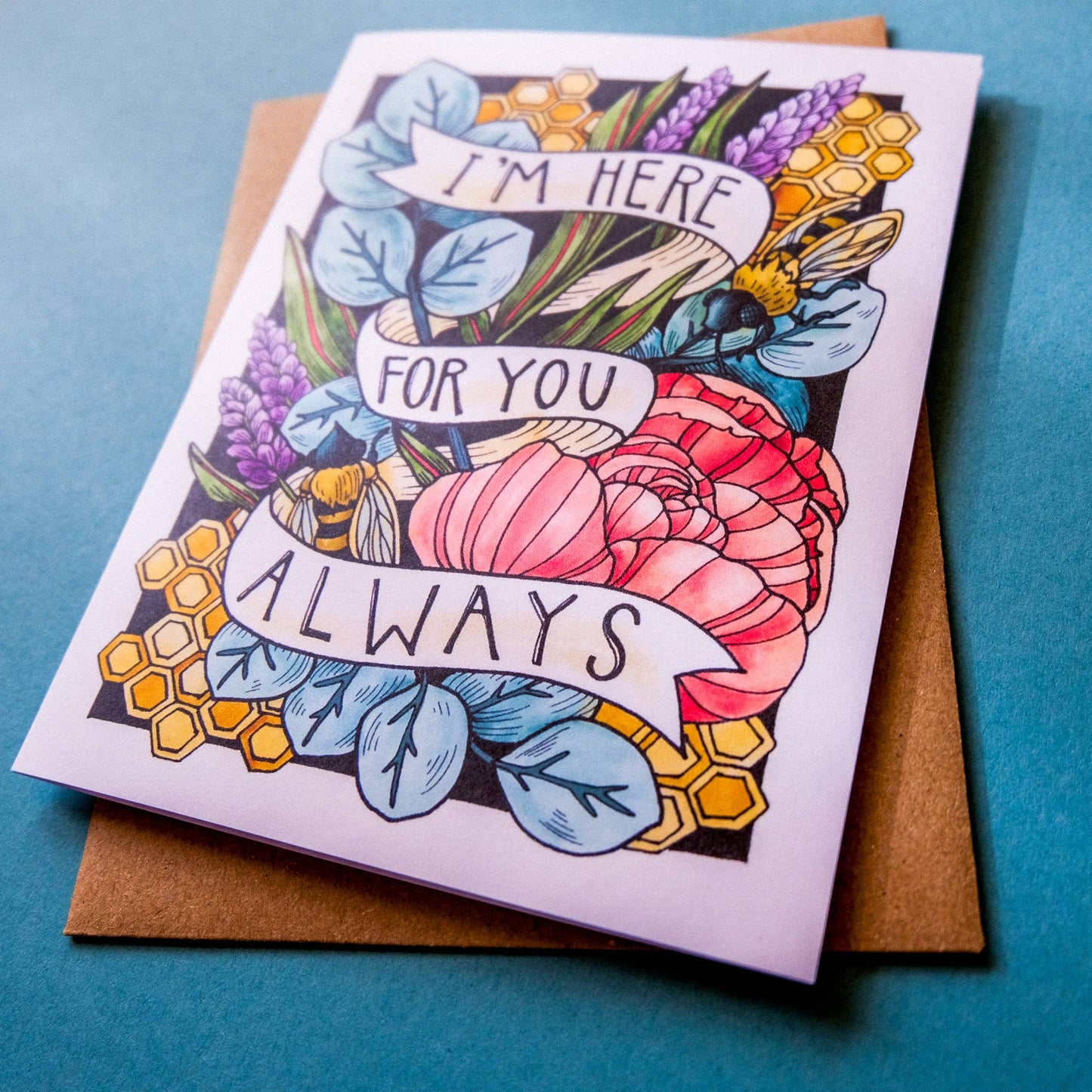 Greeting card with floral design and text 'I'm here for you always' on a blue background