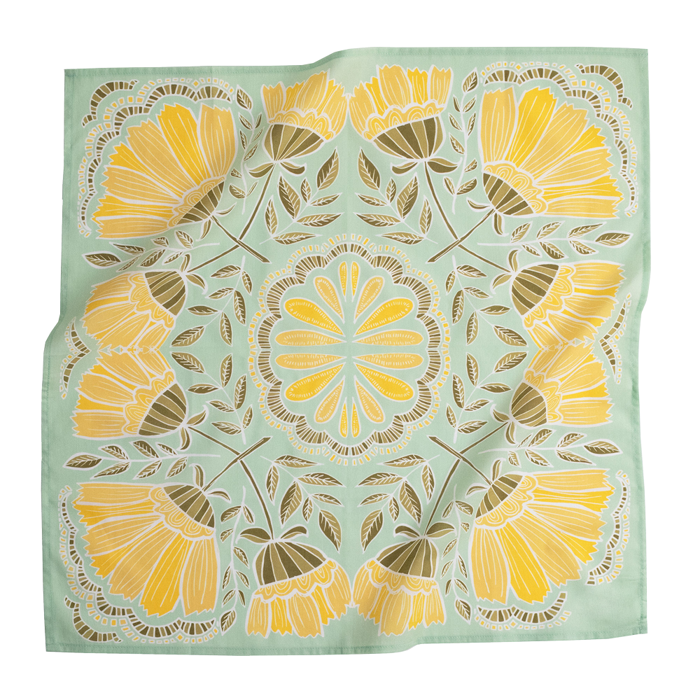 A square scarf with a symmetrical floral mandala pattern, featuring yellow and gold flowers with brown leaves on a light sage green background.