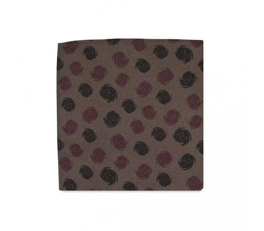 Fabric swatch with a pattern of red and black swirls on a brown background