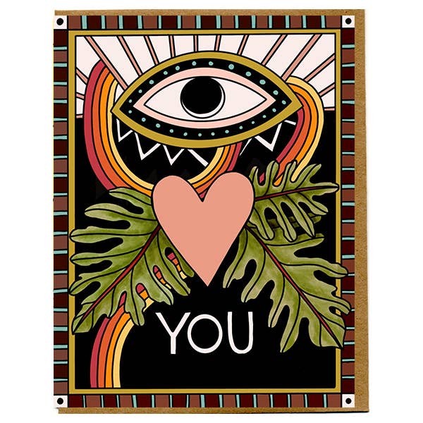 Greeting card with eye, heart, and leaves design on a black background
