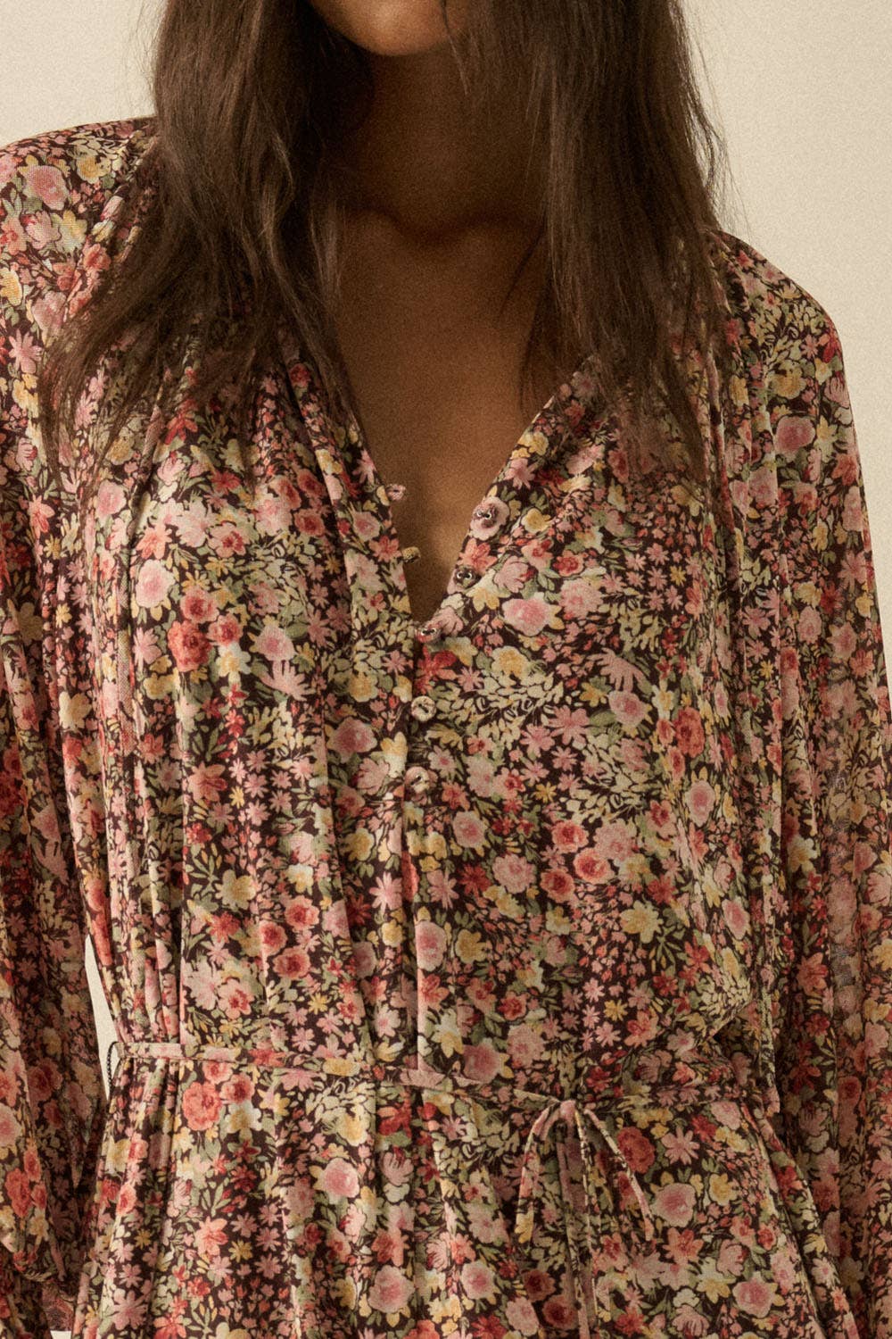 Floral patterned shirt worn by a person with a neutral background