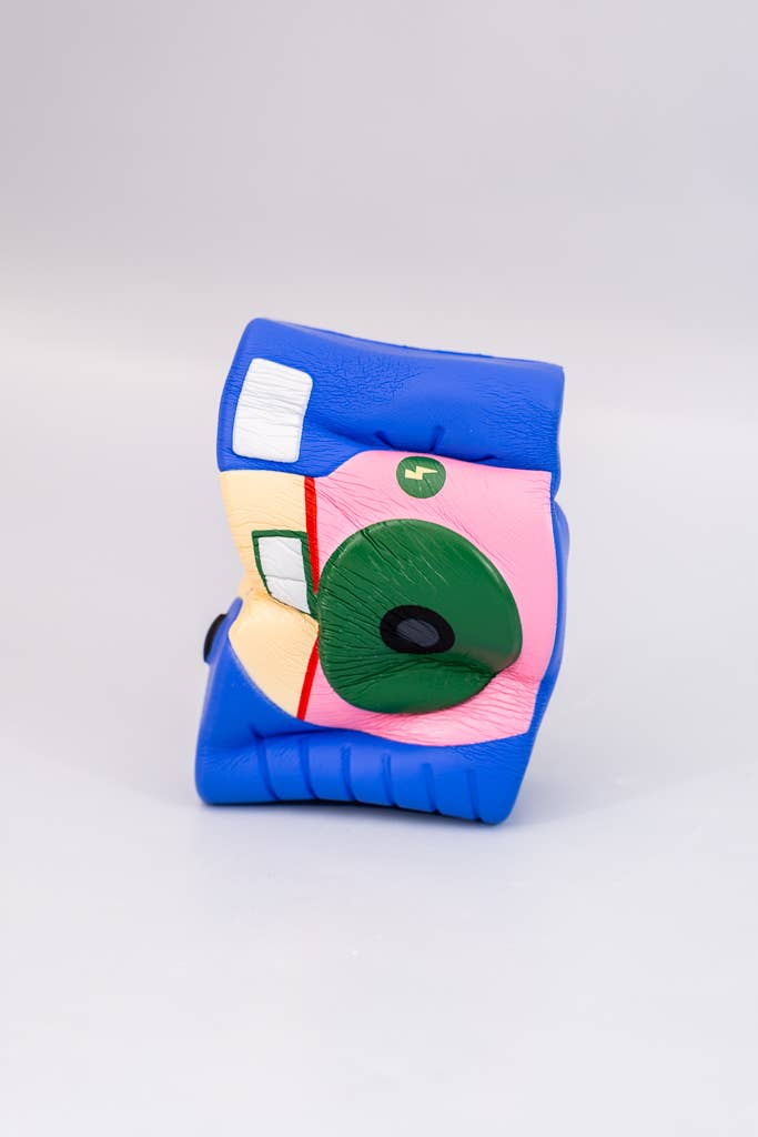 Colorful knee pad with cartoon face design on a white background