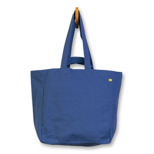 Blue tote bag with a yellow label on a white background