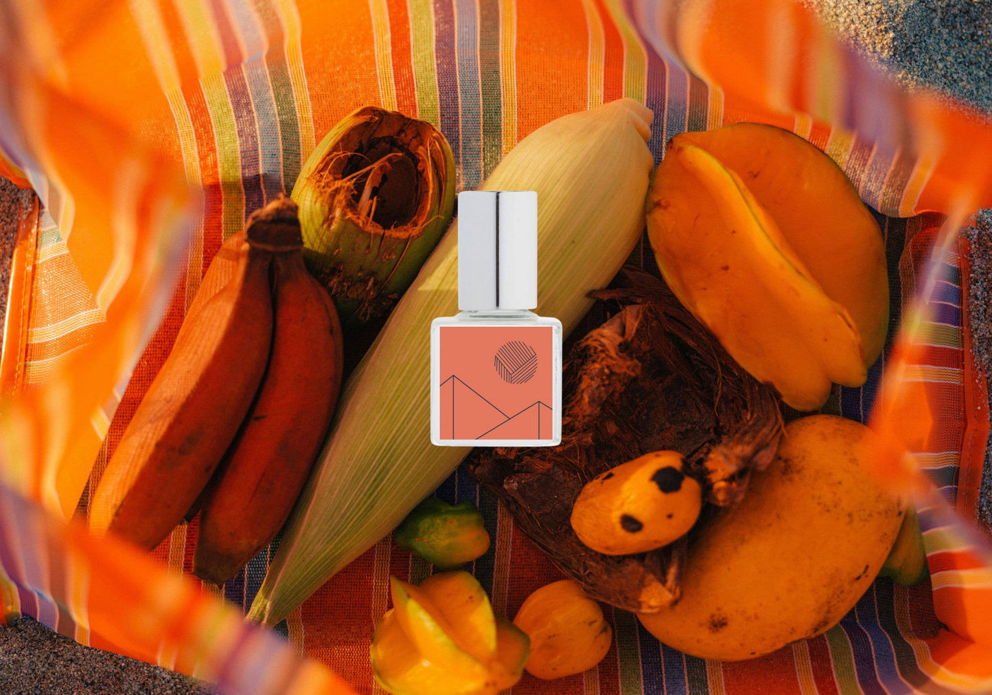 Perfume bottle with fruit and corn on a colorful striped background