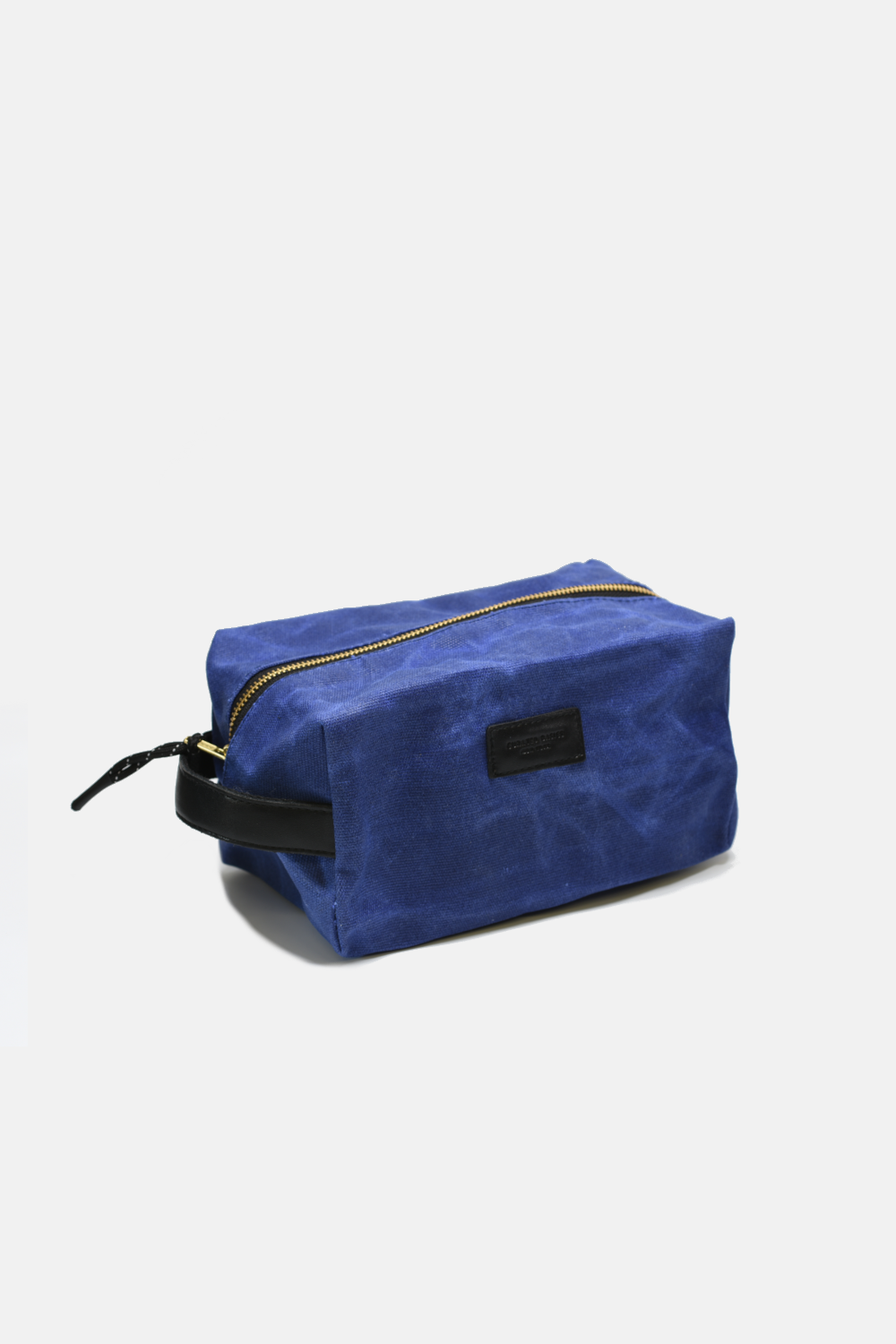 Blue toiletry bag with black strap on a white background