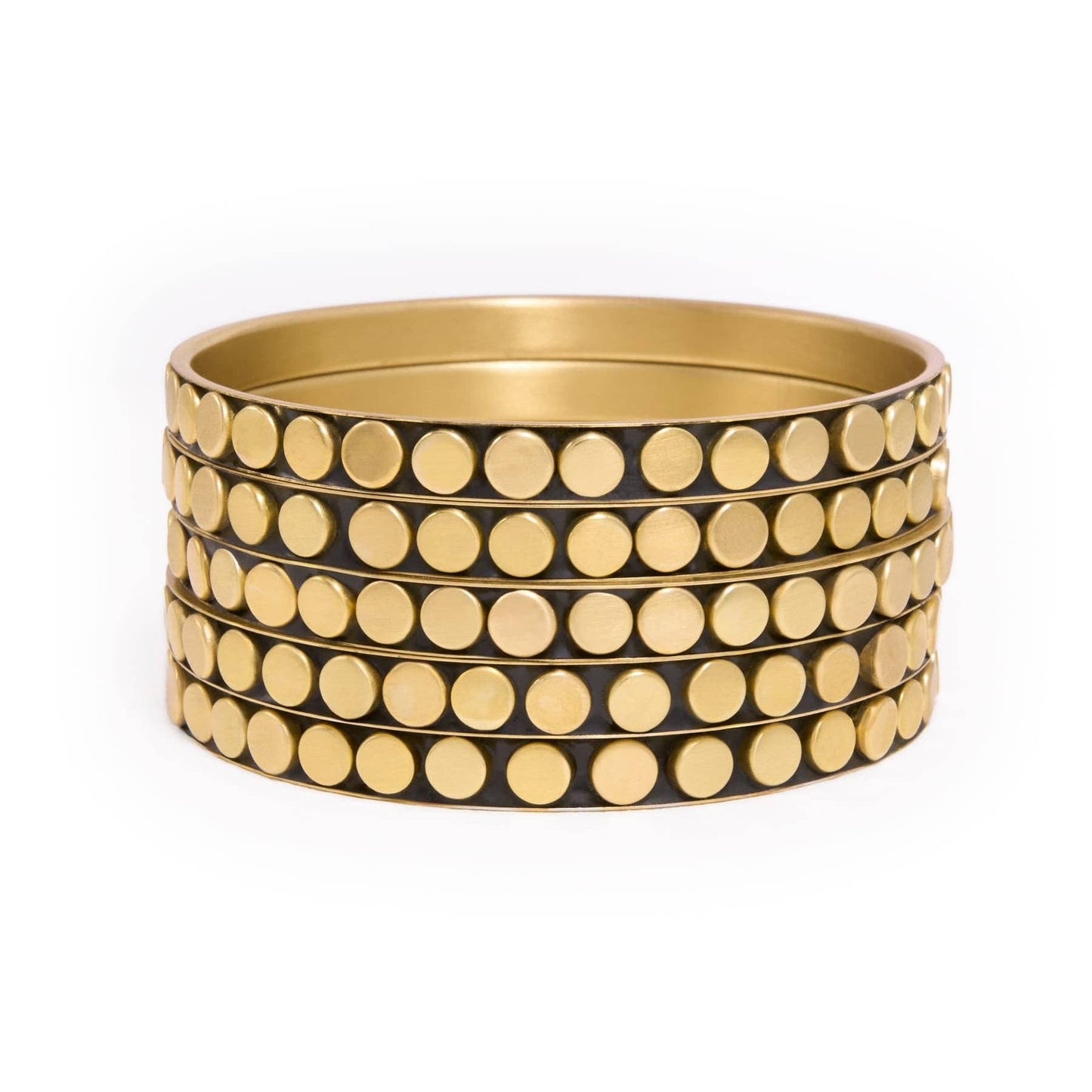 A stack of five wide gold bangles with evenly spaced circular gold studs, set against a plain white background.