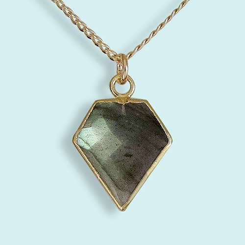 Necklace with a geometric pendant on a light blue background