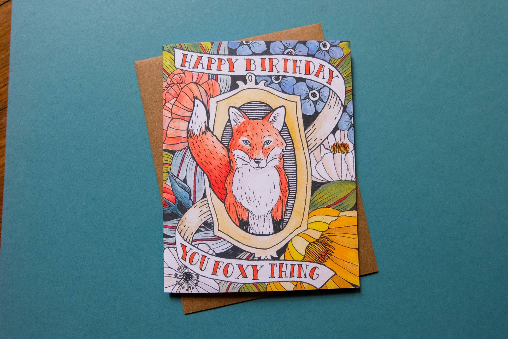 Birthday card with fox illustration on a teal background