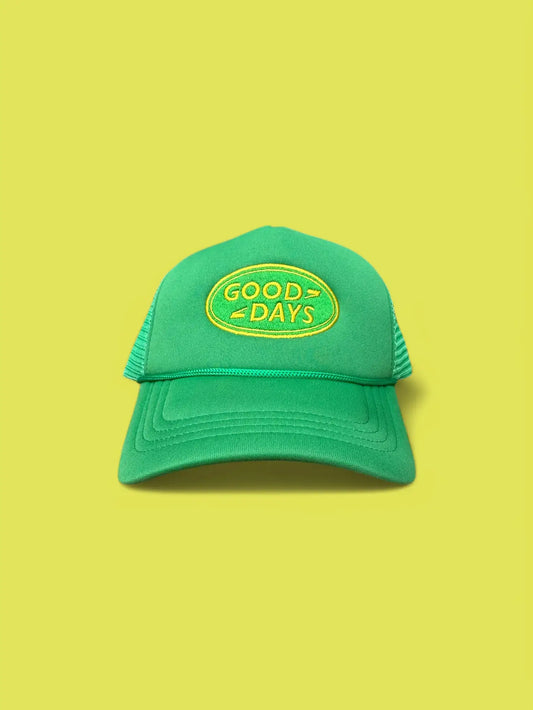 Green cap with 'Good Days' embroidery on a yellow background