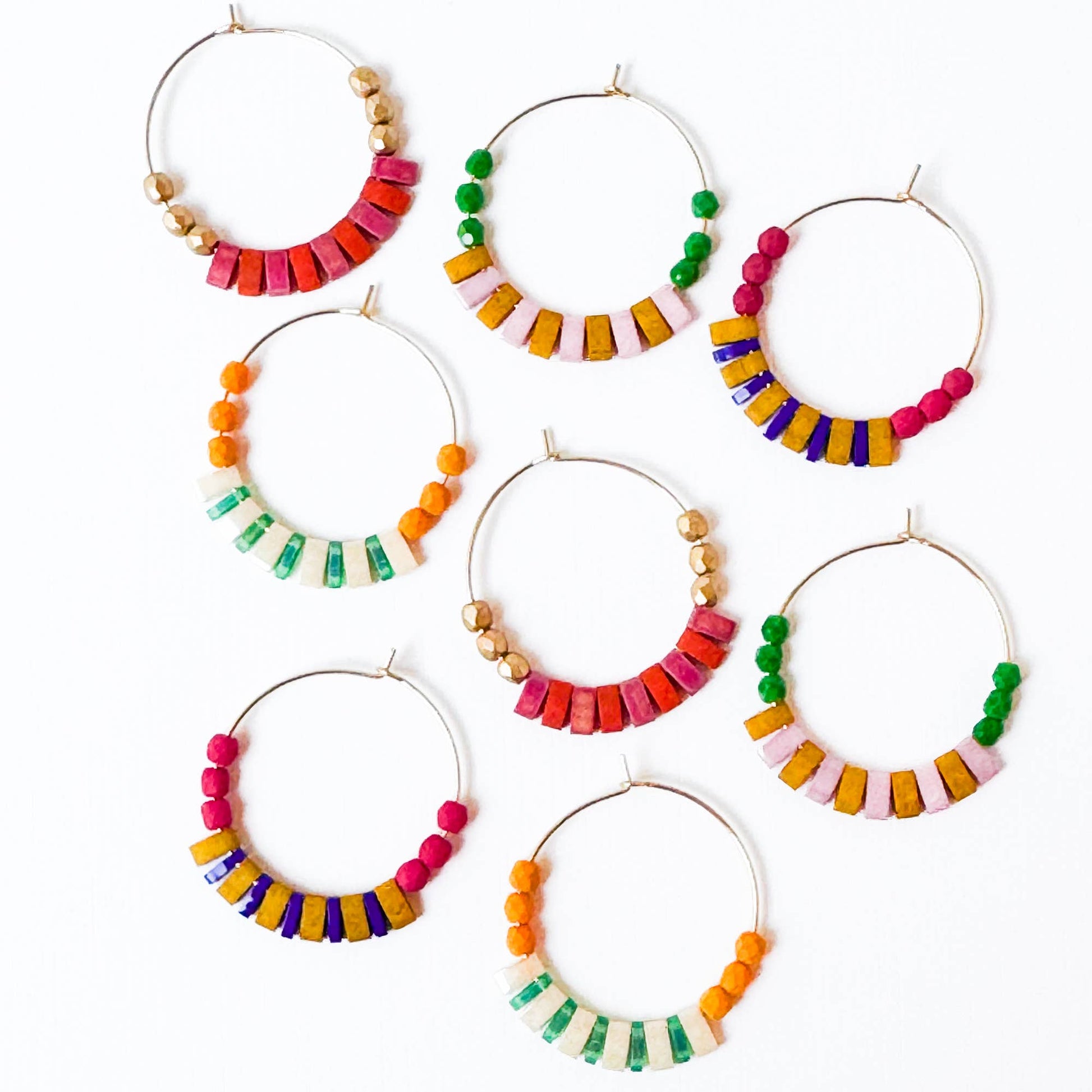 Set of colorful beaded hoop earrings on a white background