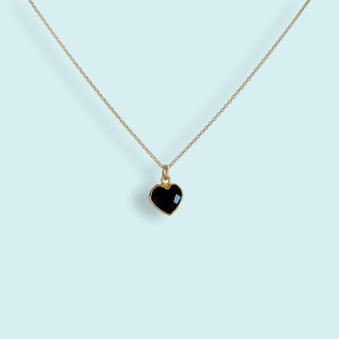 Necklace with a black heart pendant on a light blue background