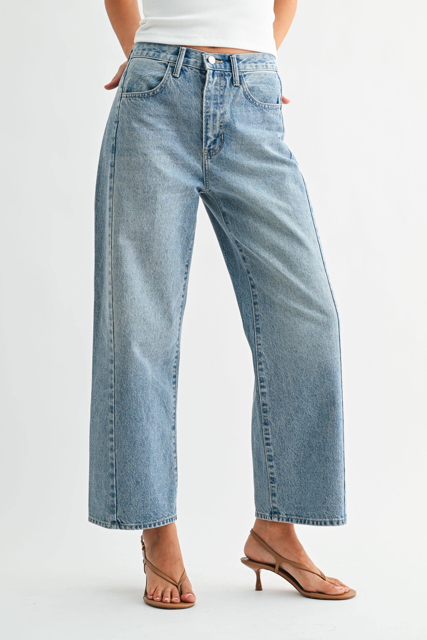 Light blue jeans worn by a person on a white background