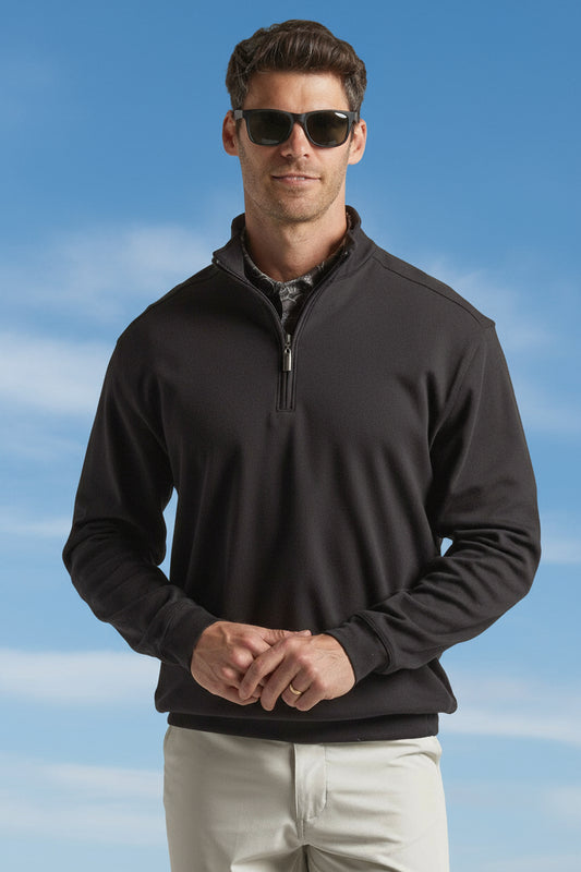Man wearing a black quarter-zip pullover on a light gray background