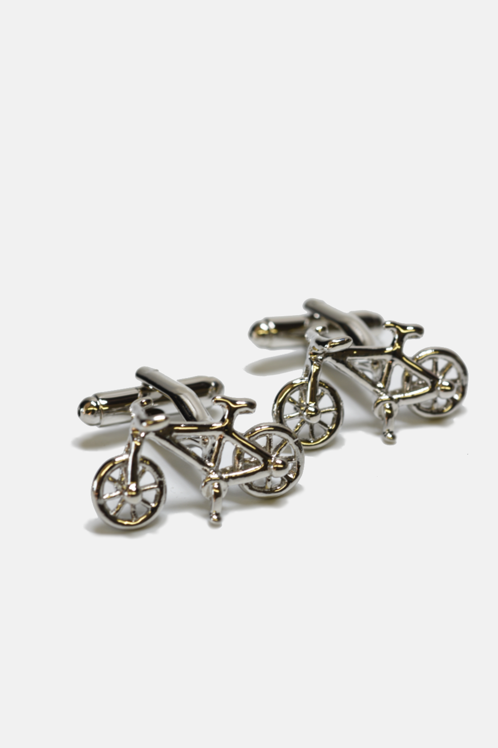 Bicycle-shaped cufflinks on a white background