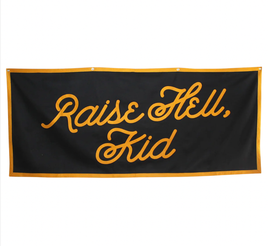 Raise Hell Kid Championship Banner, black wool felt with orange border and cursive lettering, hanging view on white background.
