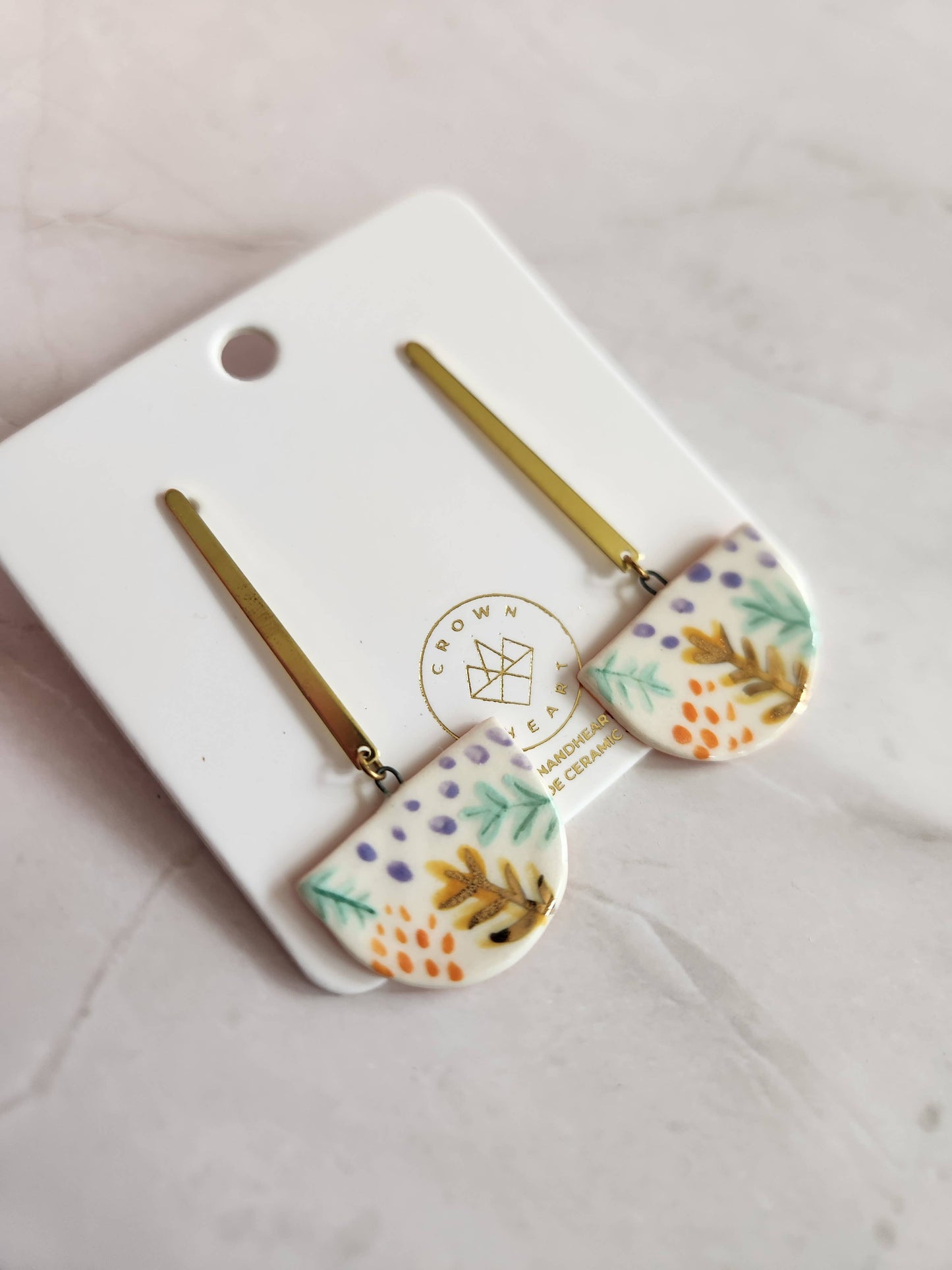 Set of floral hair pins on a white card with a brand logo.
