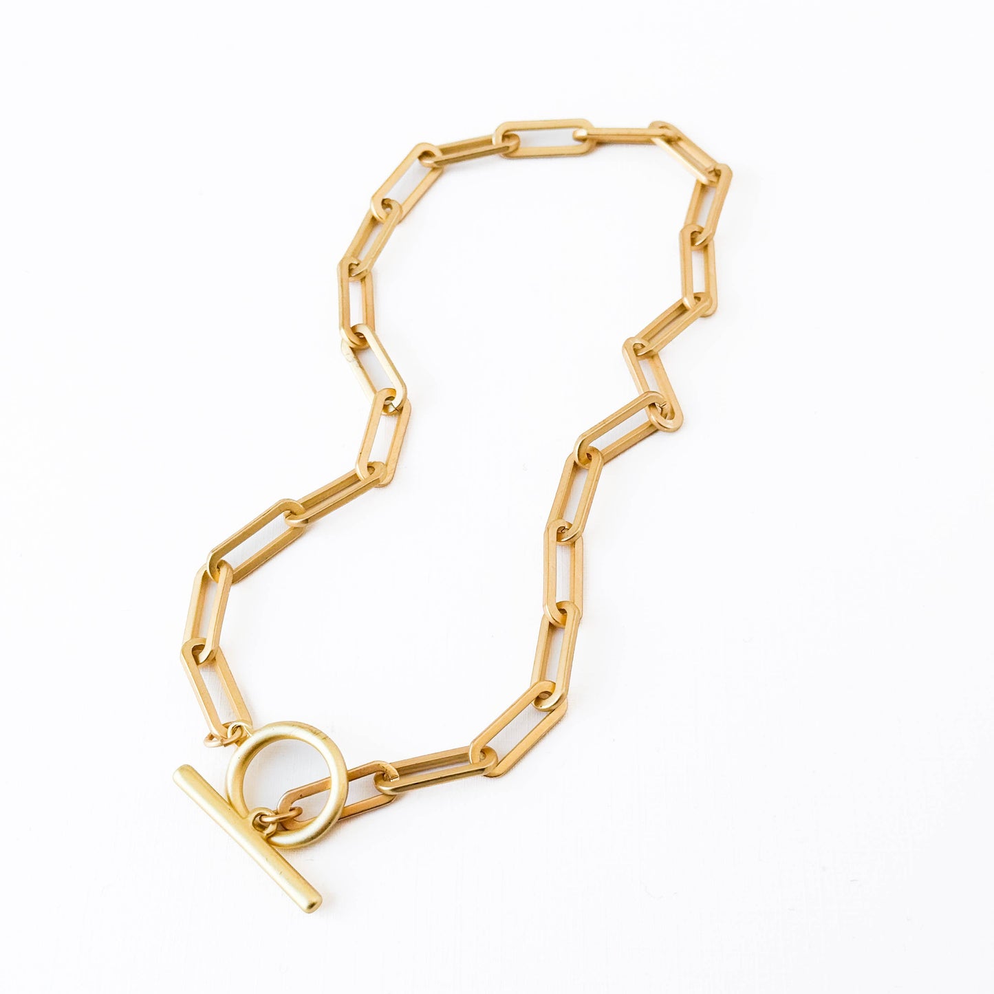 Gold chain bracelet on a white background