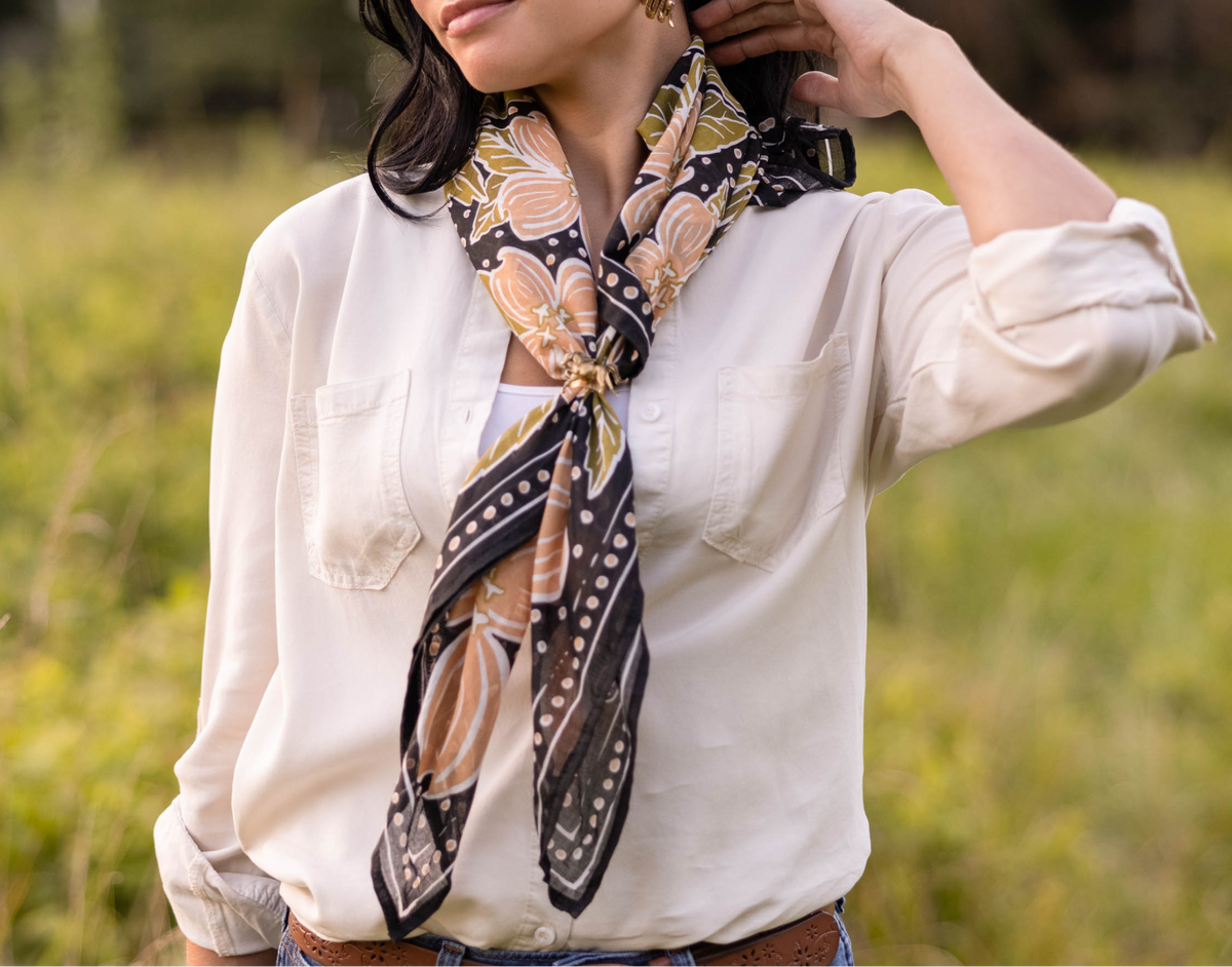 Woman wearing a patterned scarf in a natural setting