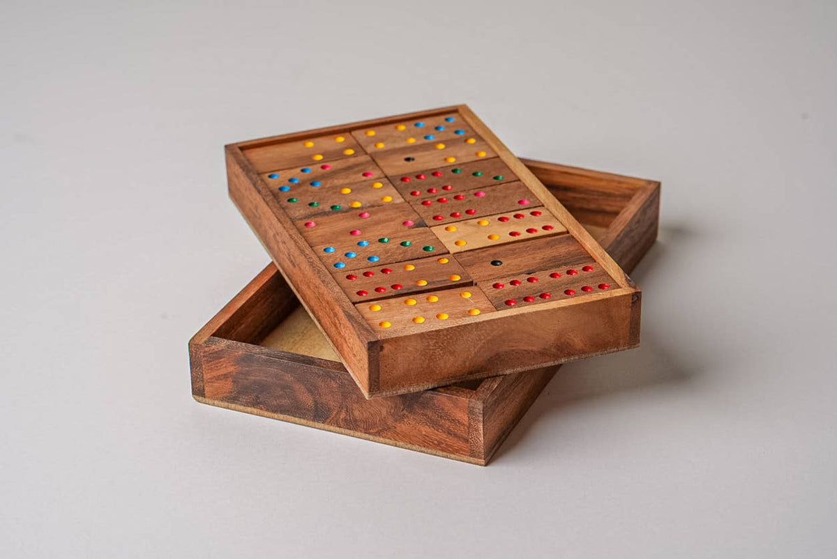 Wooden game board with colored pieces on a light gray background