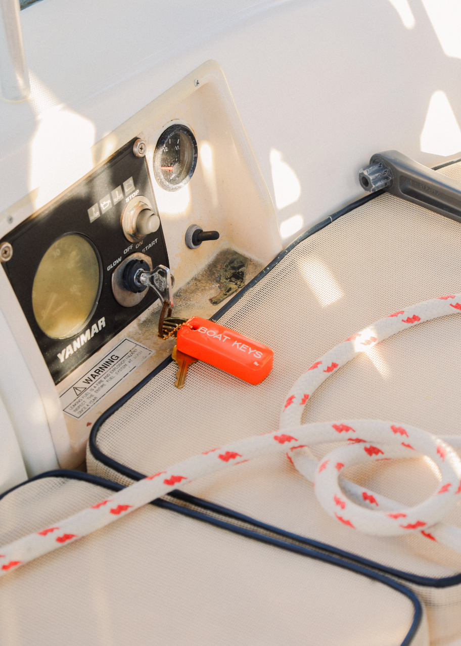 Close-up of a Yamaha outboard motor with a rope on a boat deck.