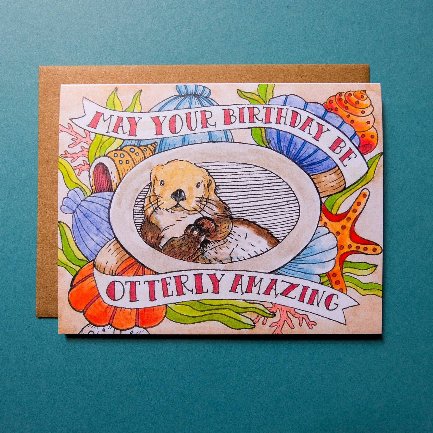 Birthday card with an otter illustration and colorful text on a blue background