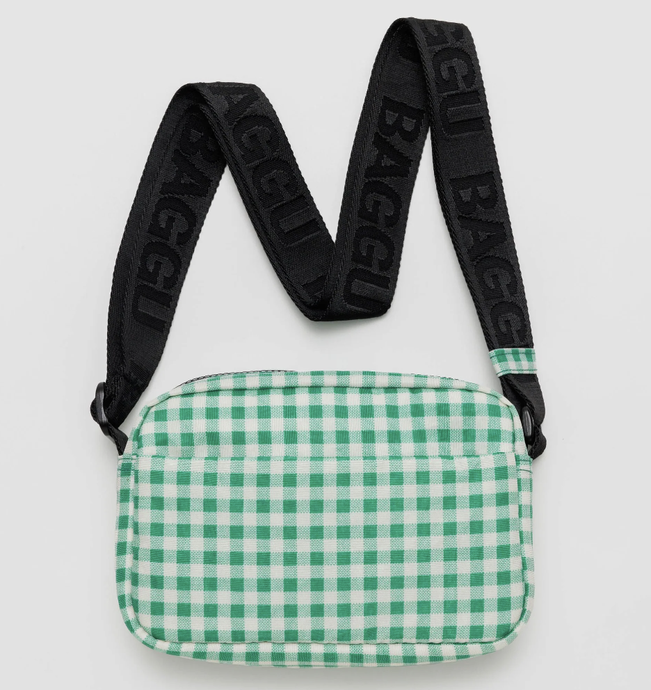 A green gingham camera crossbody bag with an adjustable black strap and the 'Baggu' logo on the flap.
