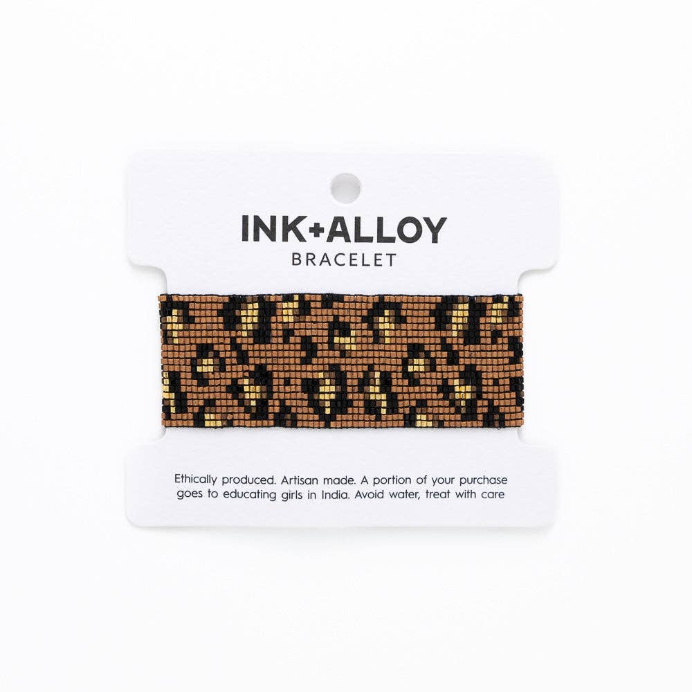 Leopard print bracelet on a white card with 'INK+ALLOY' branding.
