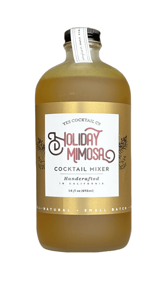 A 16 fl oz glass bottle of YES Cocktail Co. Holiday Mimosa Cocktail Mixer, filled with a golden-amber liquid and featuring a white label with red and black text, set against a plain white background.