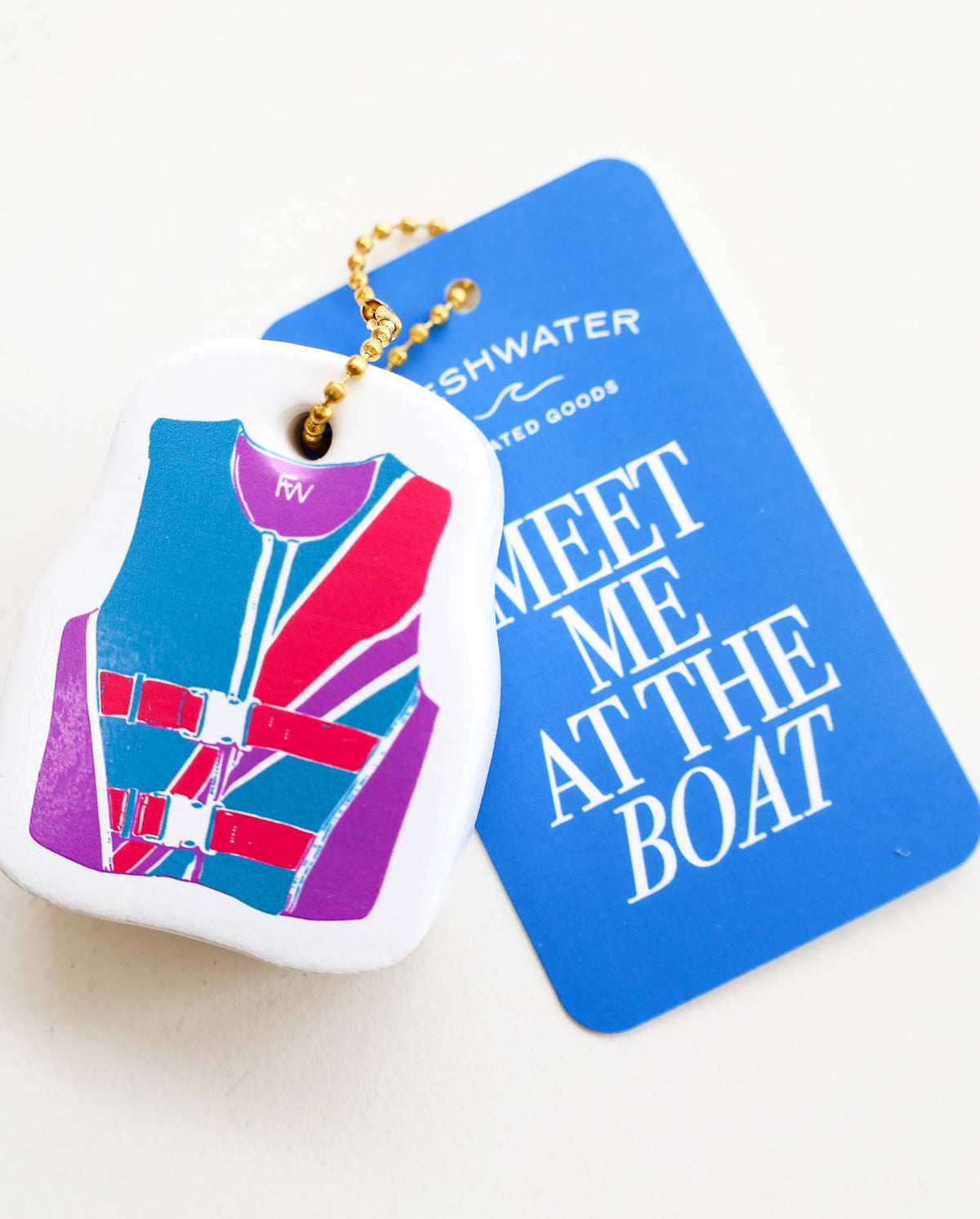 Keychain with life jacket design and blue card with text on a white background