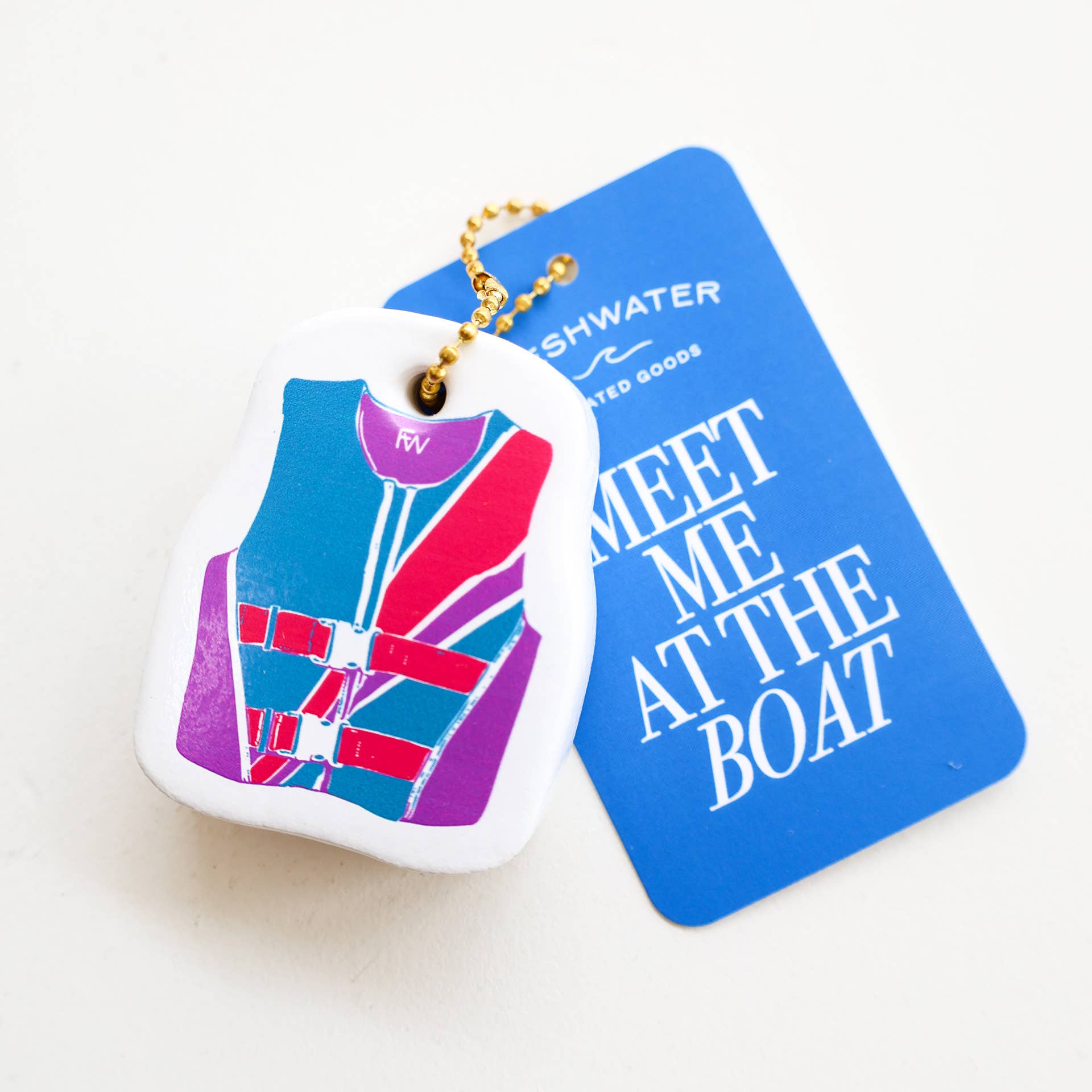 Keychain with life jacket design and blue card with text on a white background