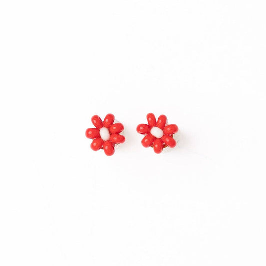 A pair of small red flower-shaped stud earrings with a white center, shown on a plain white background.