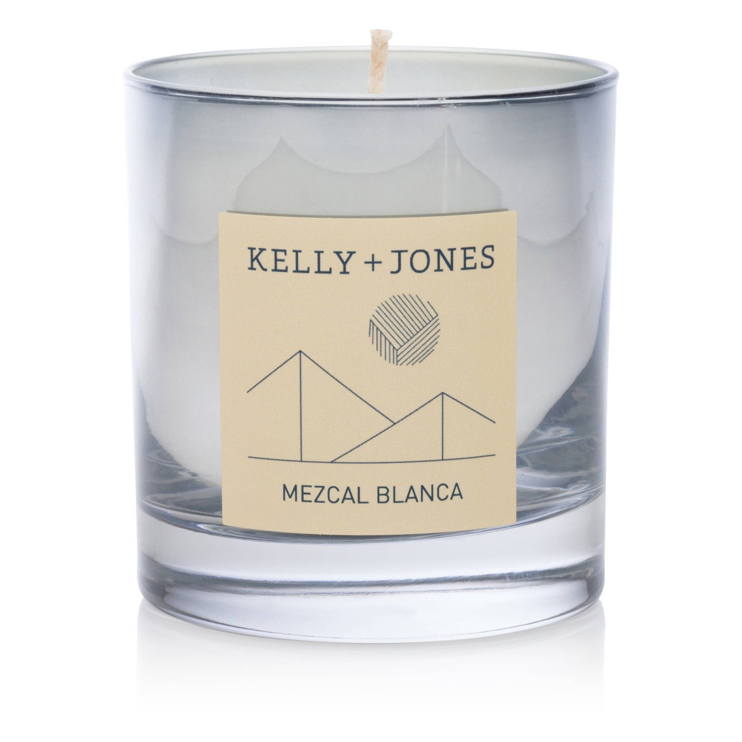 Clear glass candle with a beige label featuring 'Kelly + Jones' and 'Mezcal Blanca' on a white background.