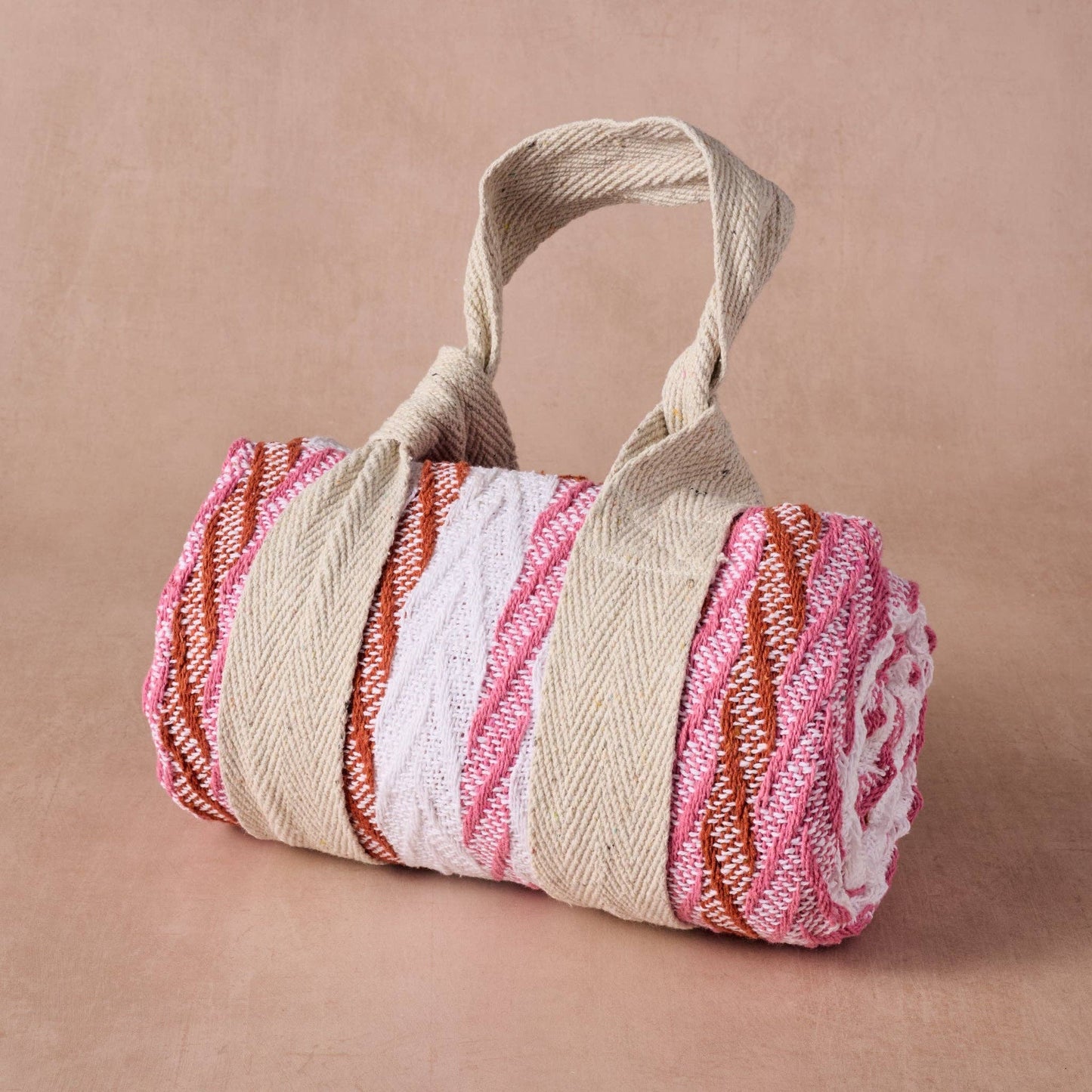 Striped woven bag with a handle on a beige background