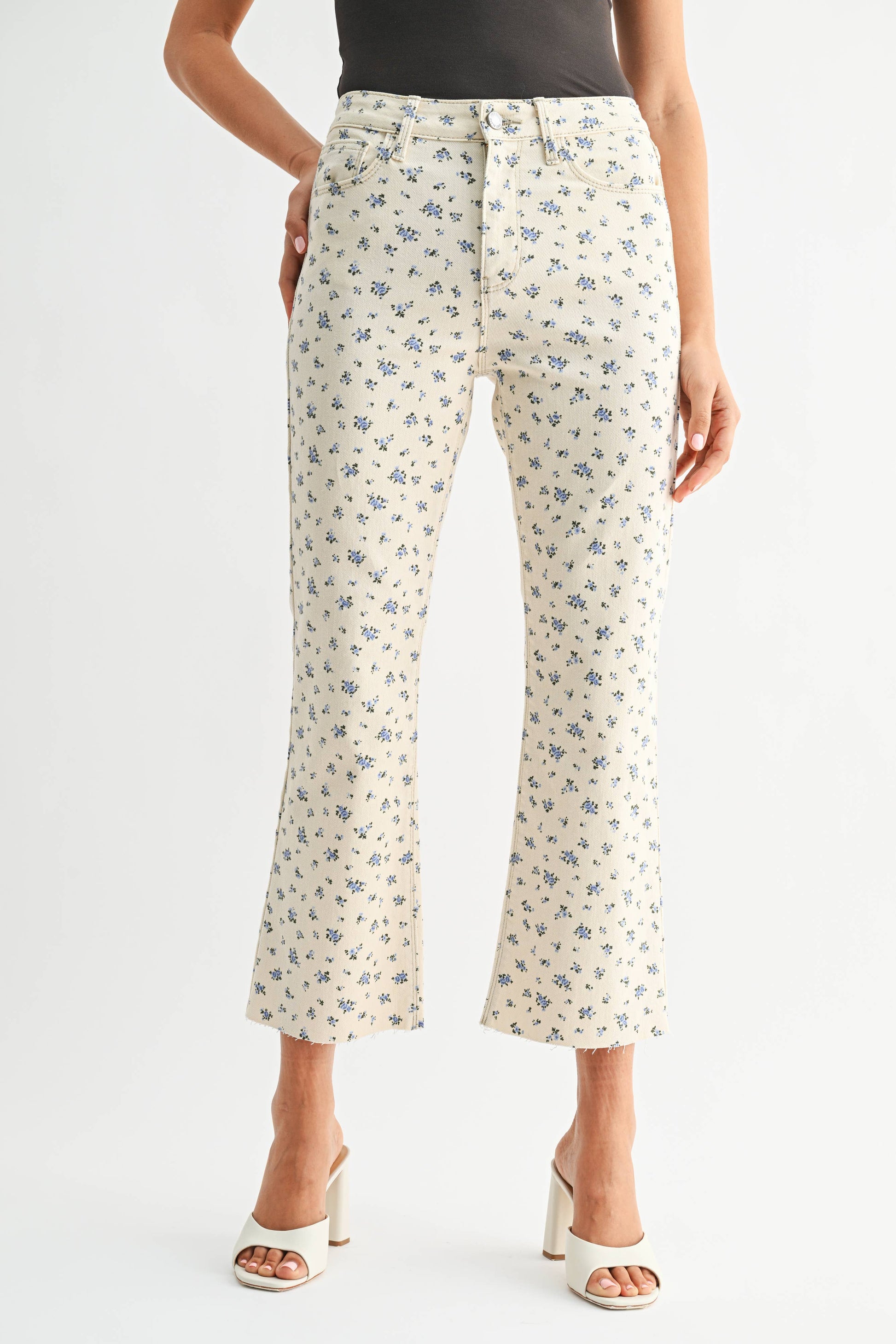Floral-patterned pants worn by a person on a white background