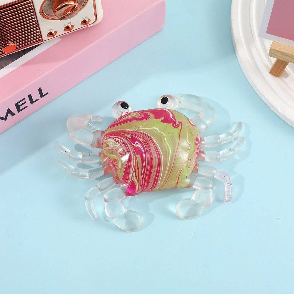 Colorful marbled crab toy on a light blue background
