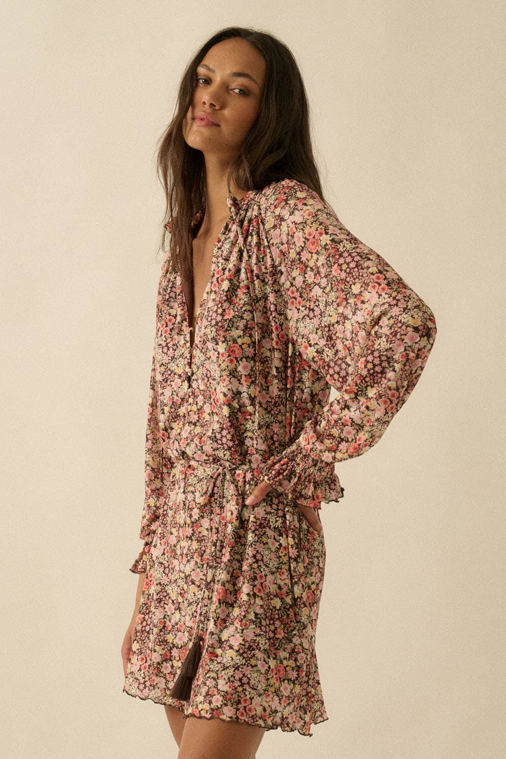 Woman wearing a floral dress against a beige background
