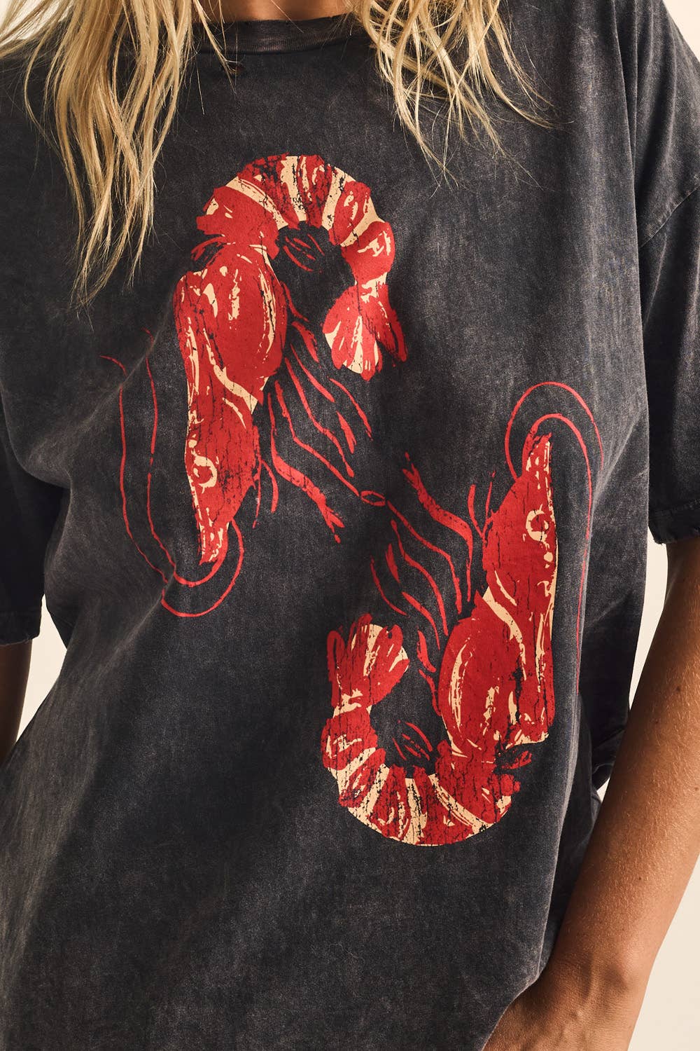 Black t-shirt with red snake design worn by a person