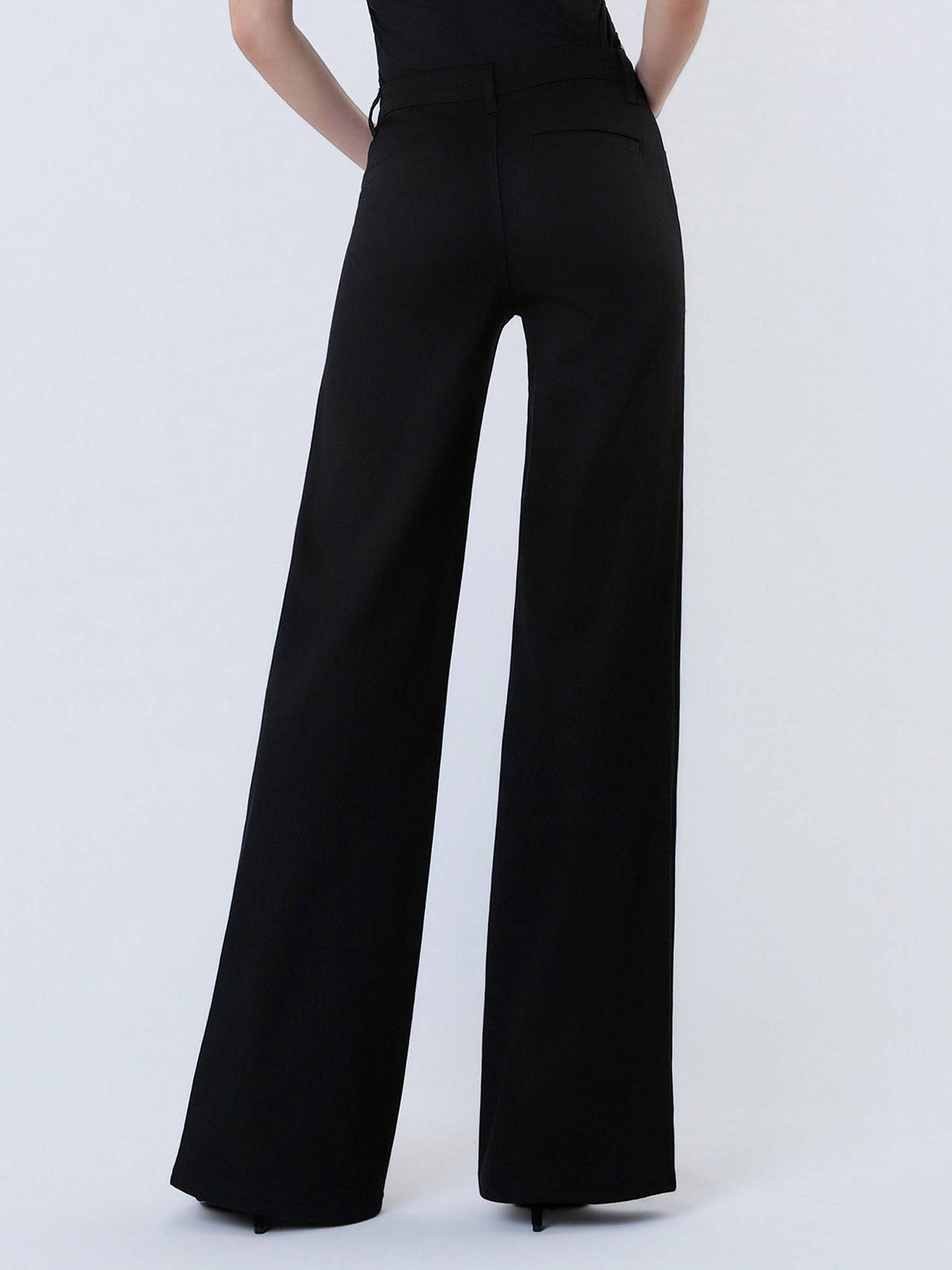 Black wide-leg pants worn by a person on a white background
