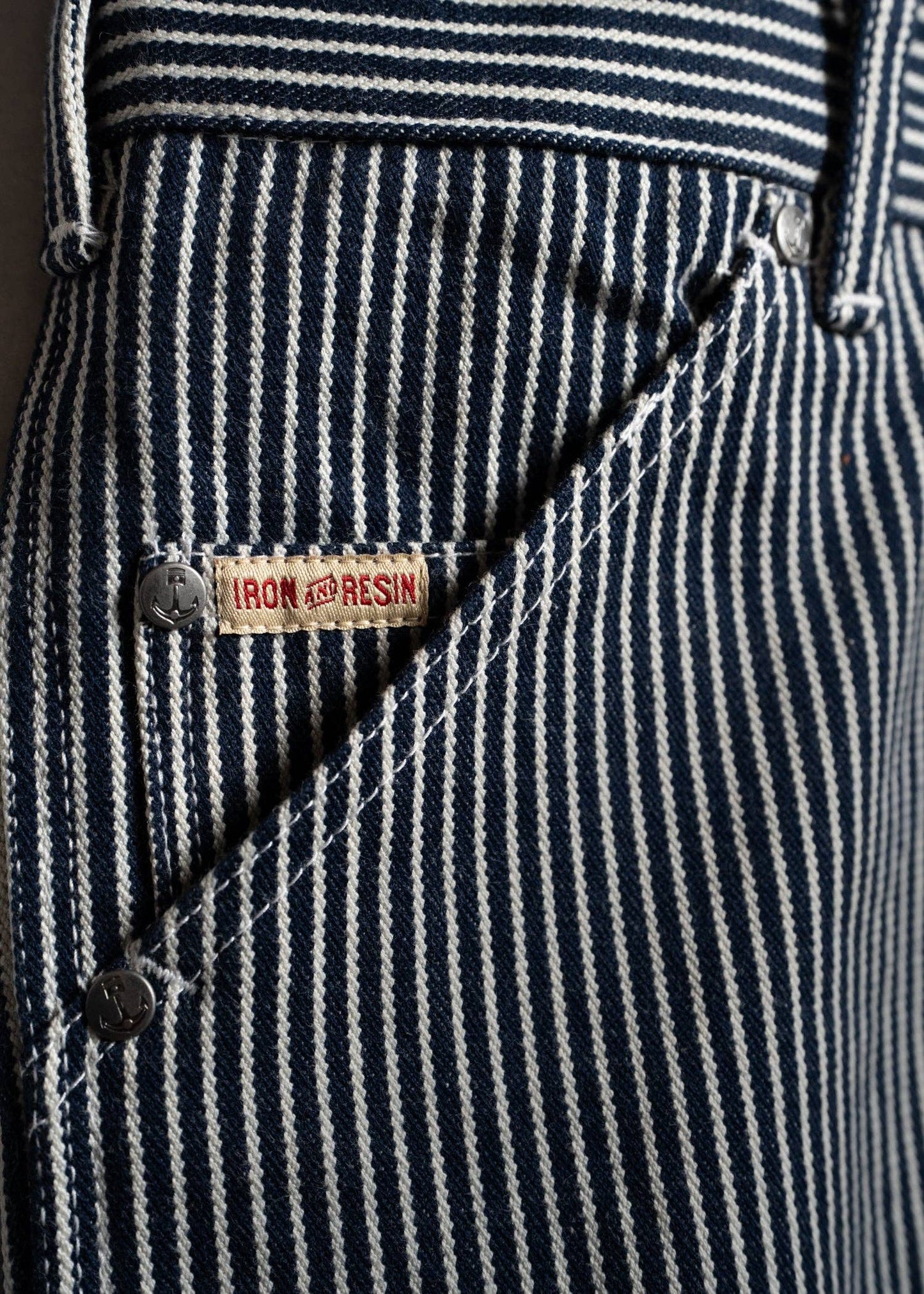 Close-up of a navy and white striped fabric with a brand label.