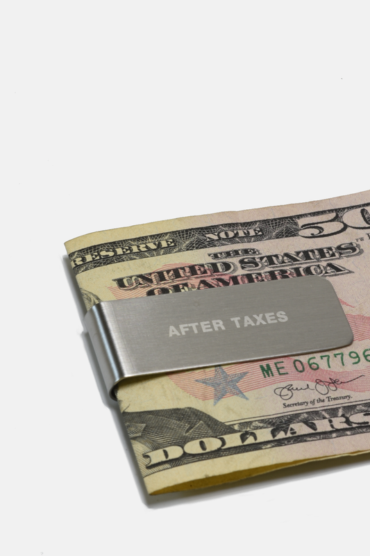 Money clip on a folded dollar bill with 'After Taxes' text
