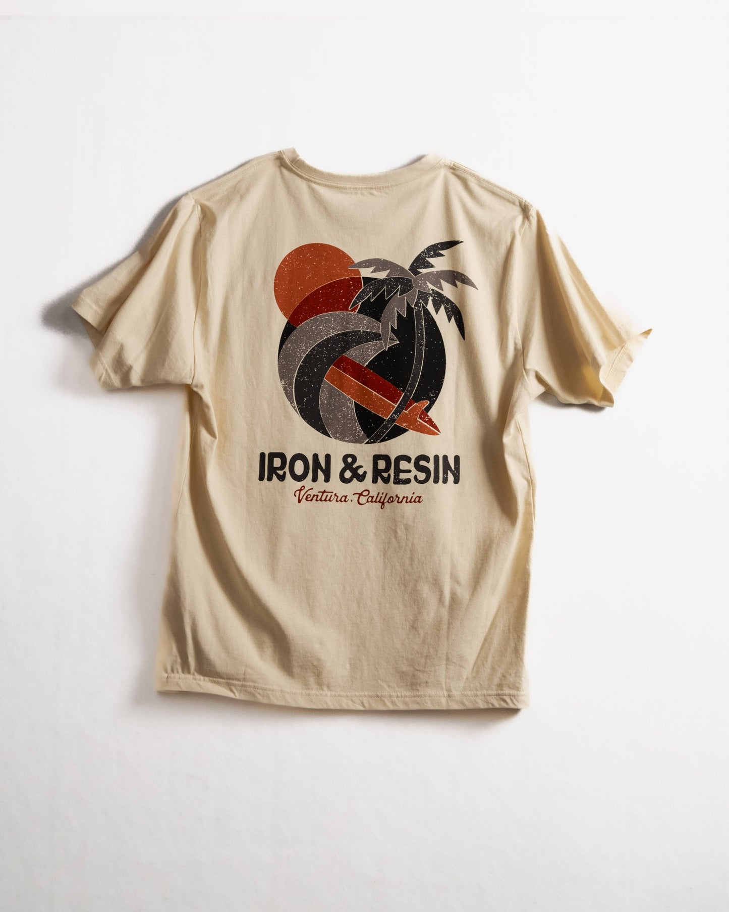 Beige t-shirt with a graphic design and 'Iron & Resin' text on a white background