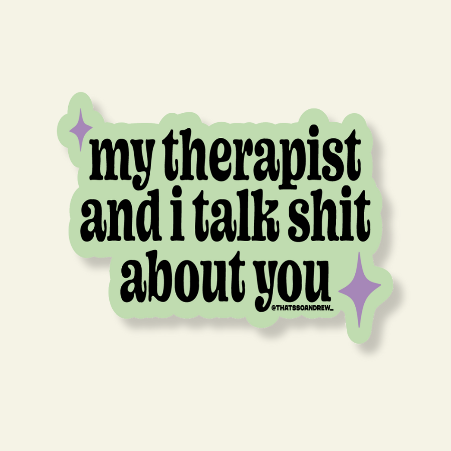 A die-cut sticker with a light green border and black text reading 'my therapist and i talk shit about you' on a warm off-white background. Small purple sparkle graphics appear near the corners, and a tiny 'STAKESANDREW' mark is printed at the bottom right.