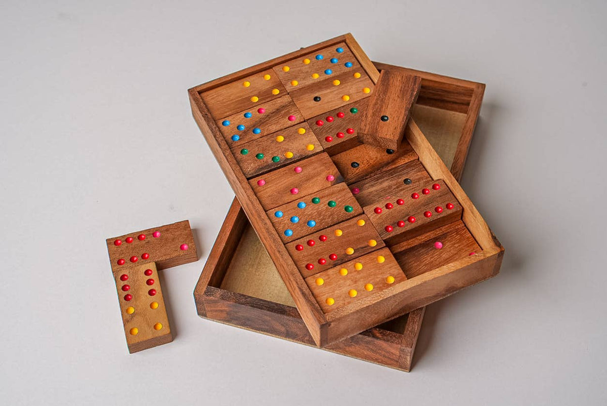 Wooden game board with colorful pegs on a light gray background
