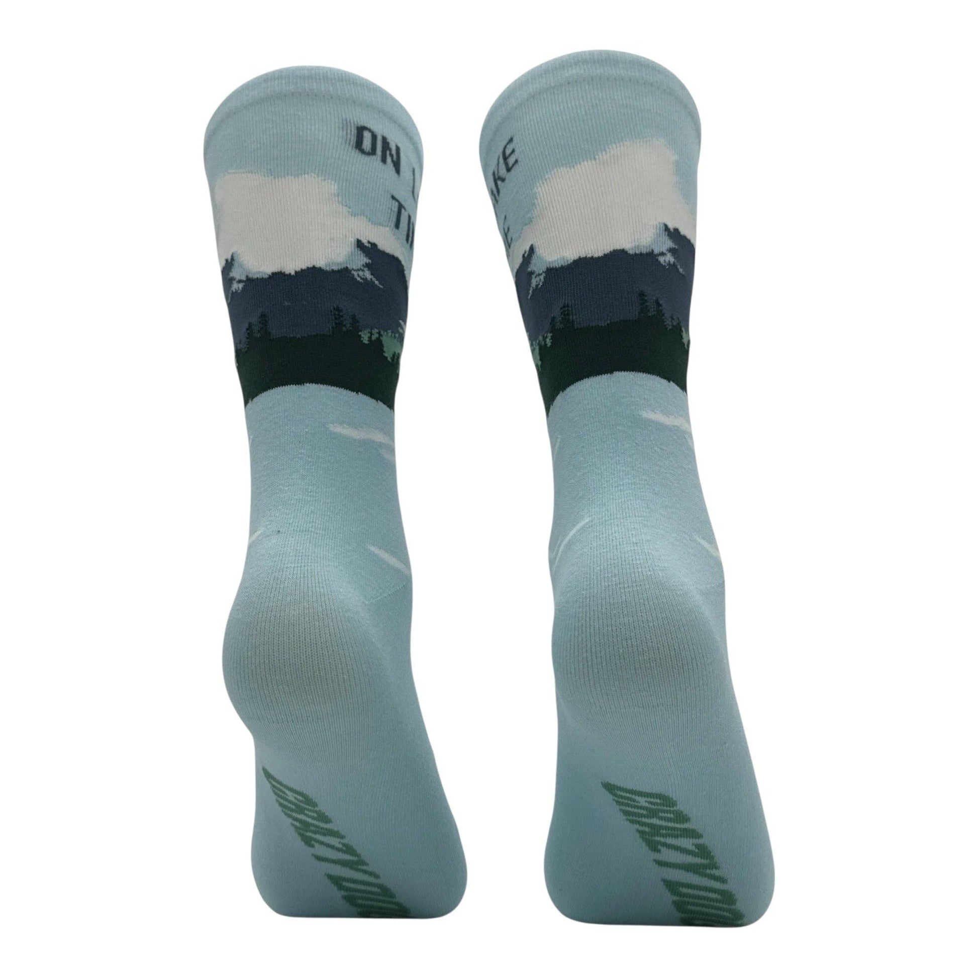 Pair of socks with nature design and text on a white background