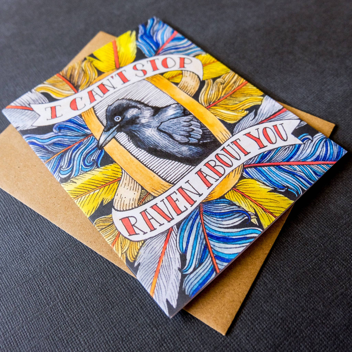 Greeting card with a bird illustration and colorful text on a dark surface