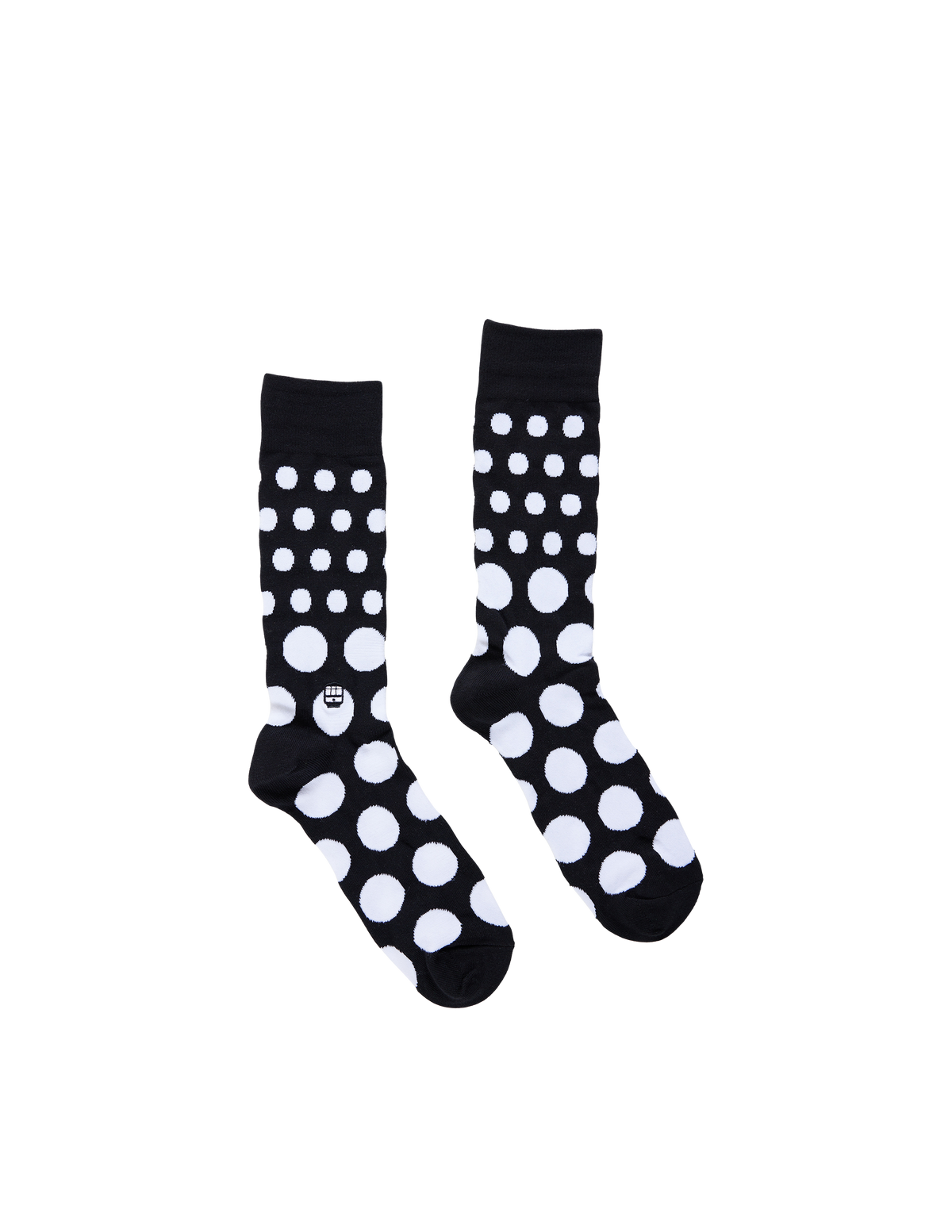 A pair of black crew socks with a white polka dot pattern, displayed against a solid white background.