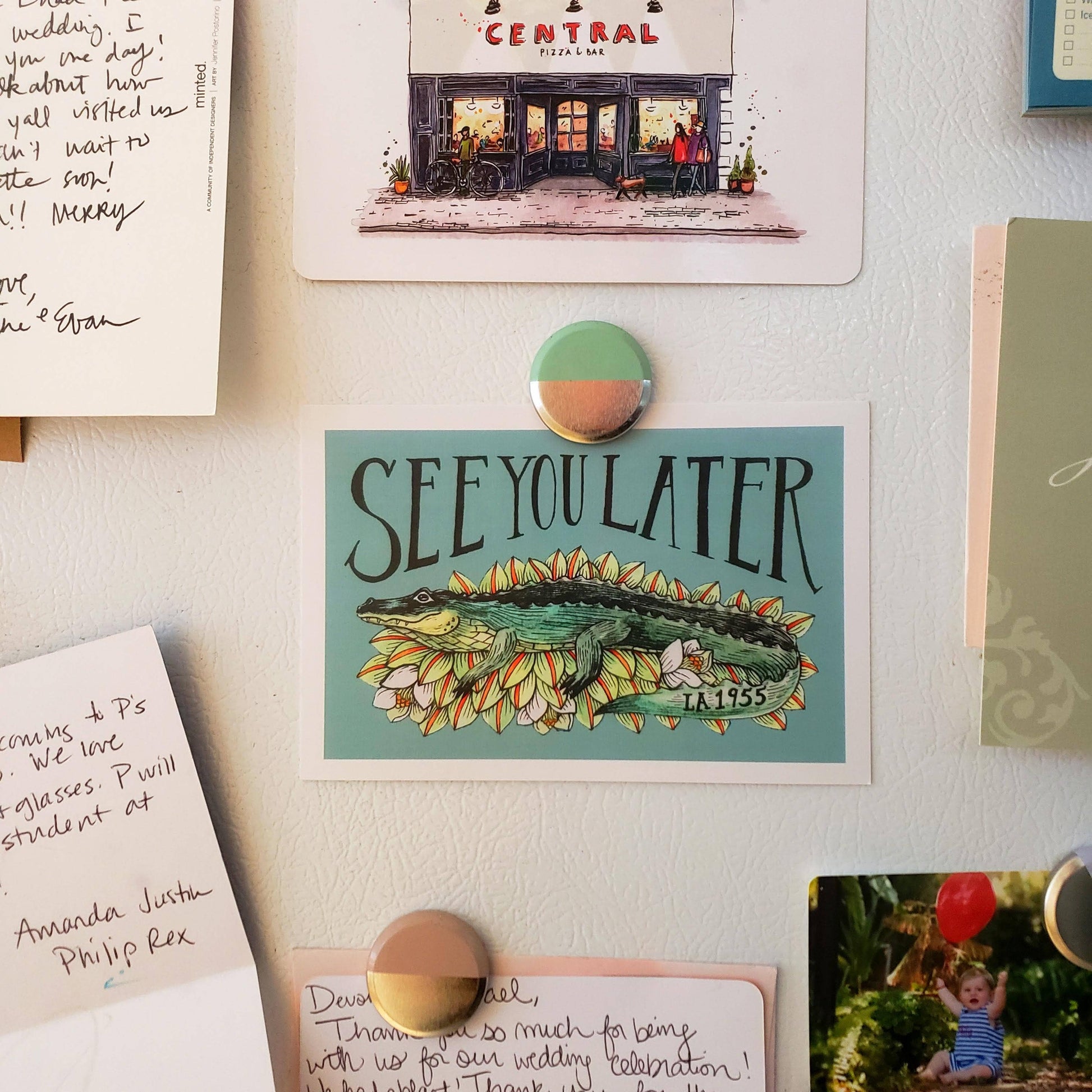 Fridge with various magnets, notes, and a 'See You Later' magnet with an alligator illustration.
