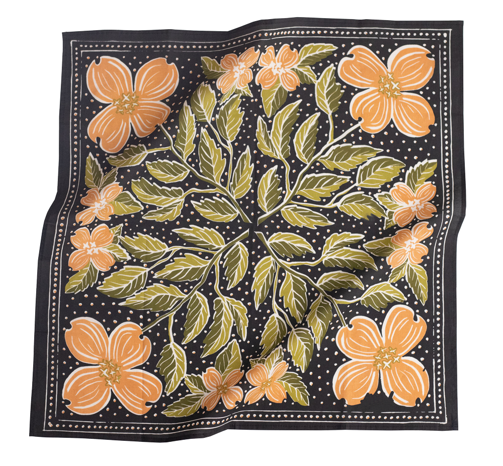 Floral patterned fabric with orange flowers and green leaves on a black background